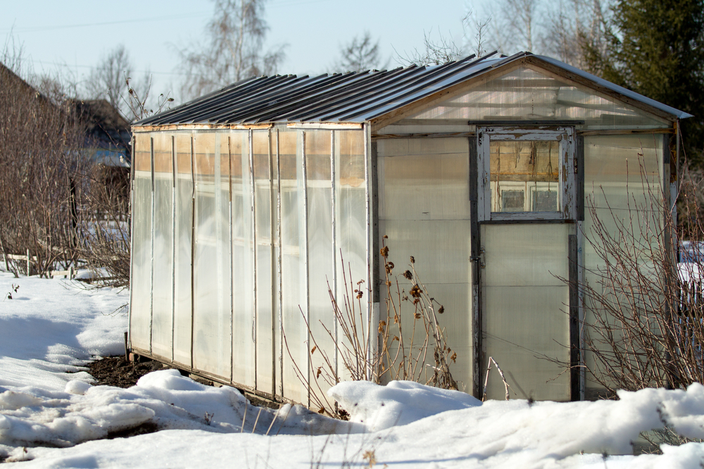 plastic hothouse in winter garden0